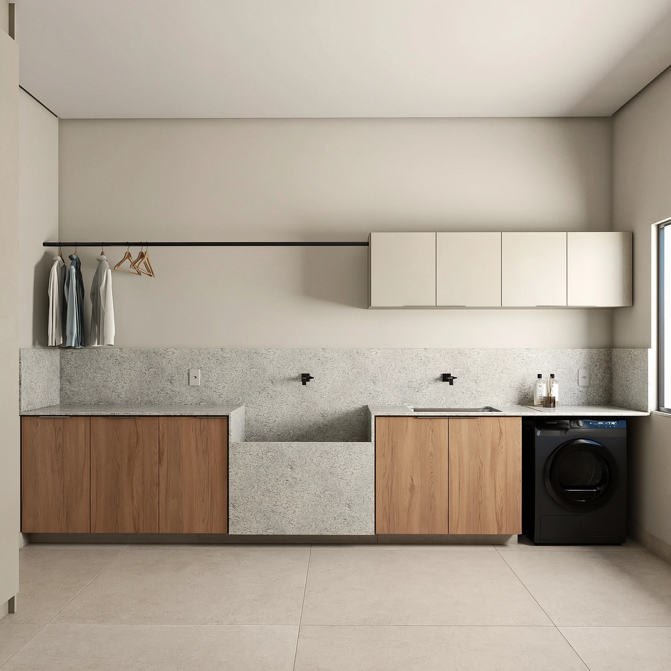 Laundry at Elena House, with stone sink, oak cabinets and a washing machine
