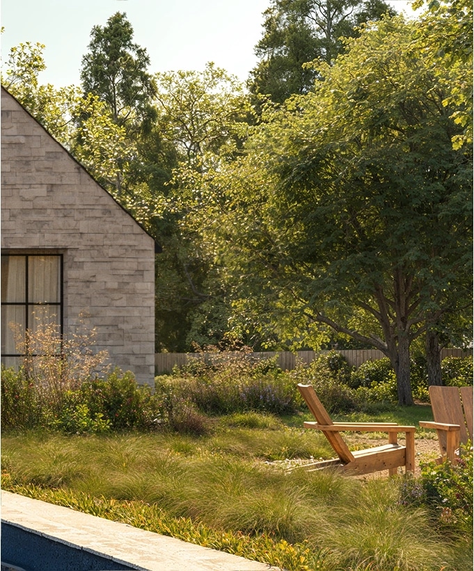 Pool terrace at Elena House, with lounge seating and still water